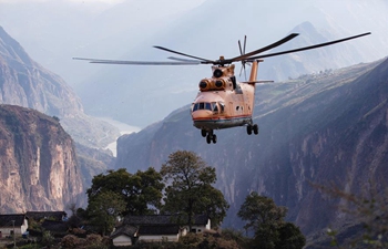 Mi-26 heavy transport helicopter used to help transport machinery for road contruction